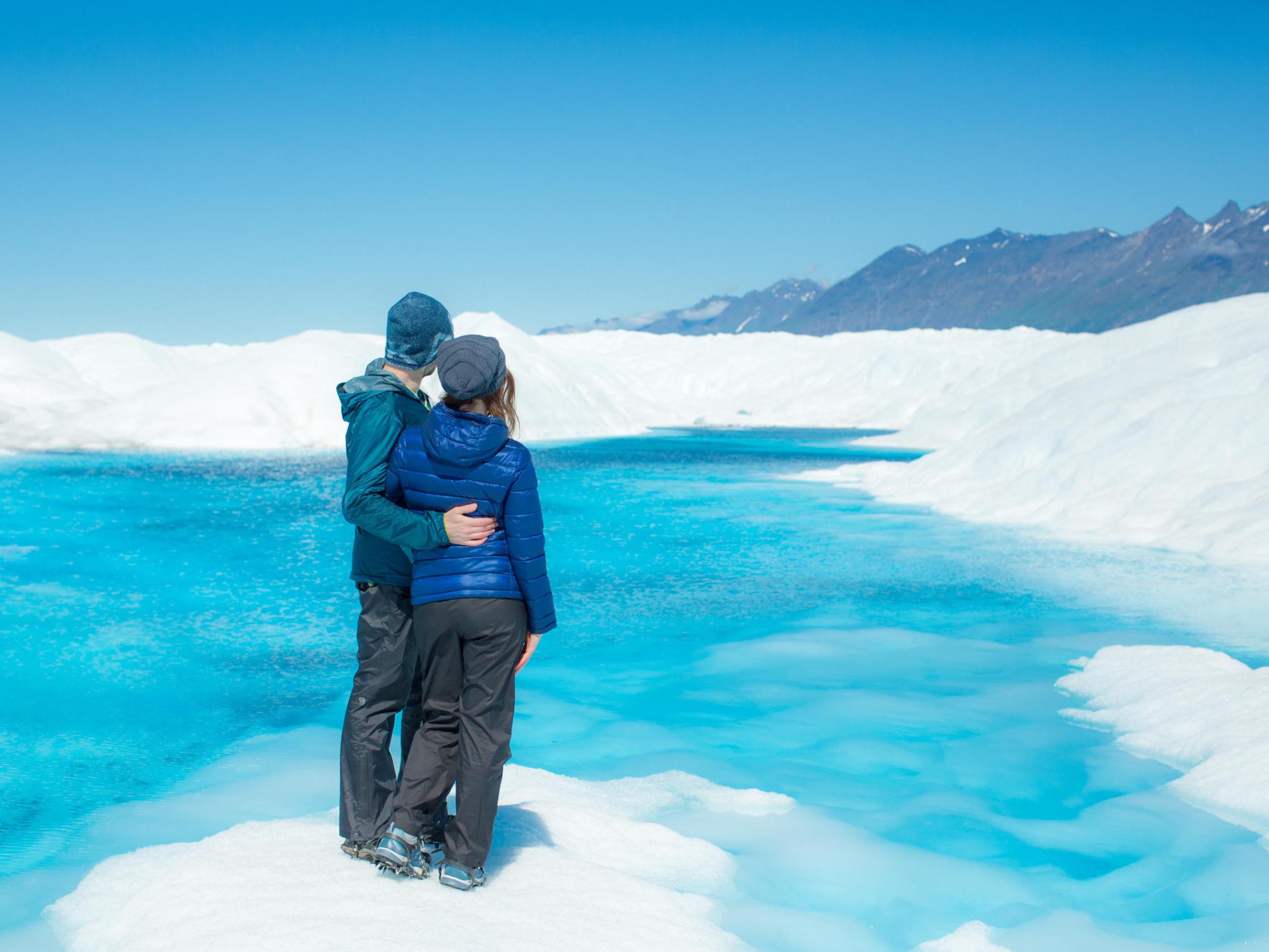 a man standing on top of a snow covered mountain