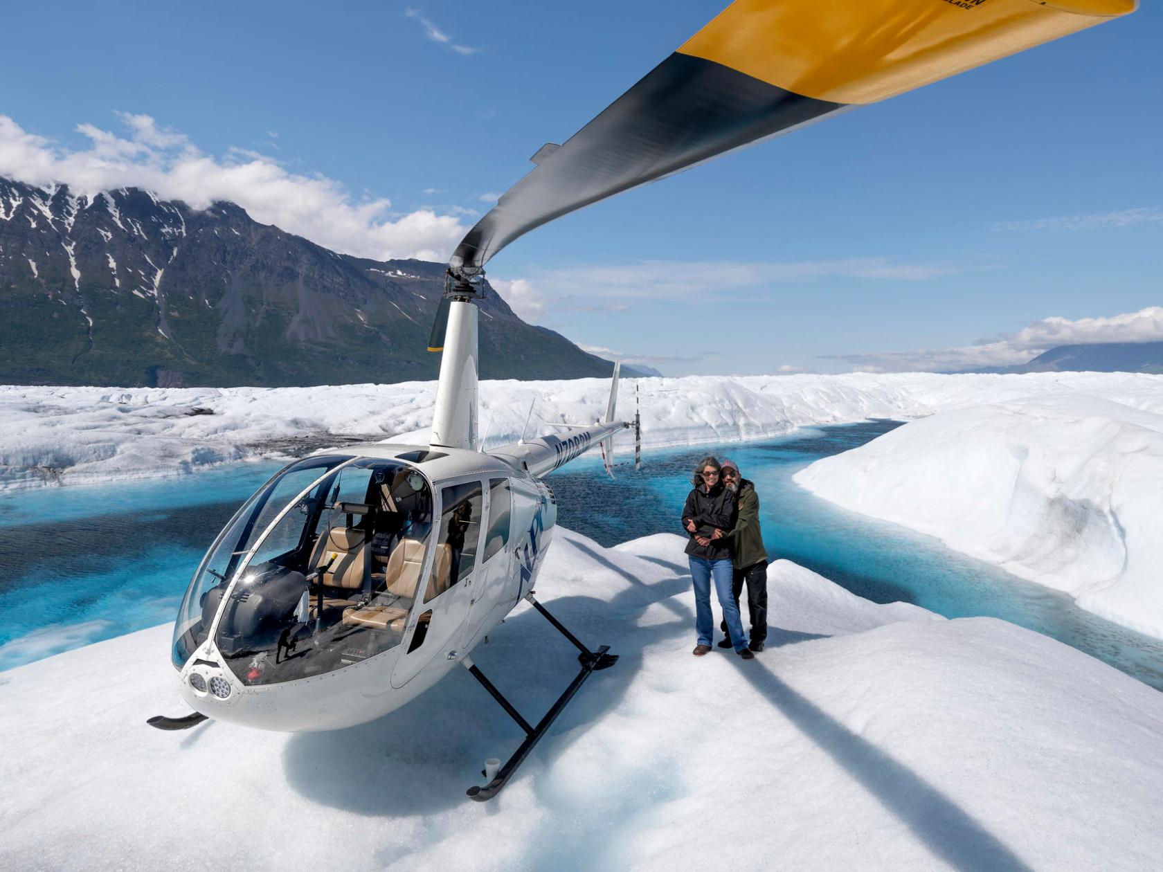 a man riding a snowboard down a snow covered slope
